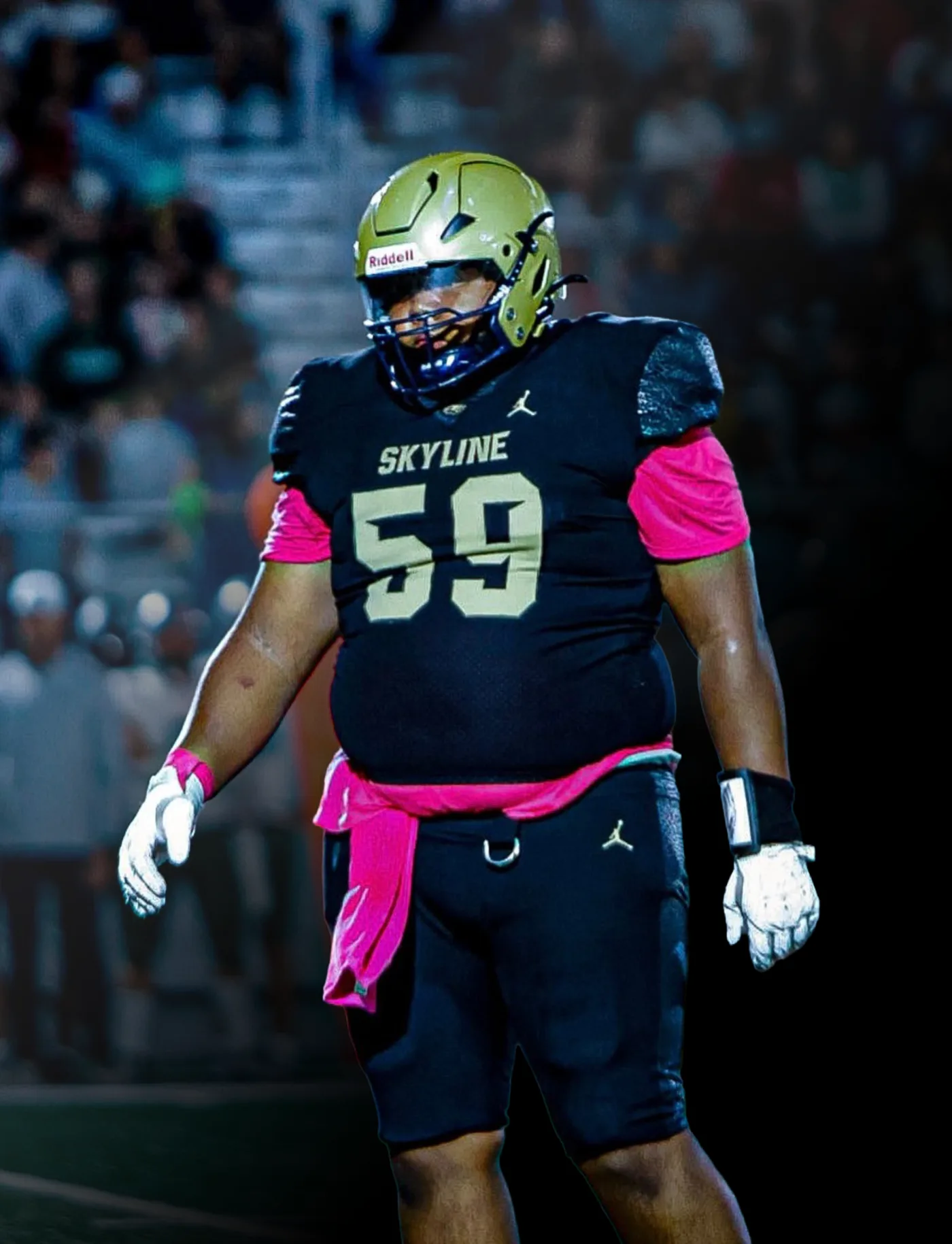 Ammon Sanchez #59 in Skyline High School football uniform under stadium lights